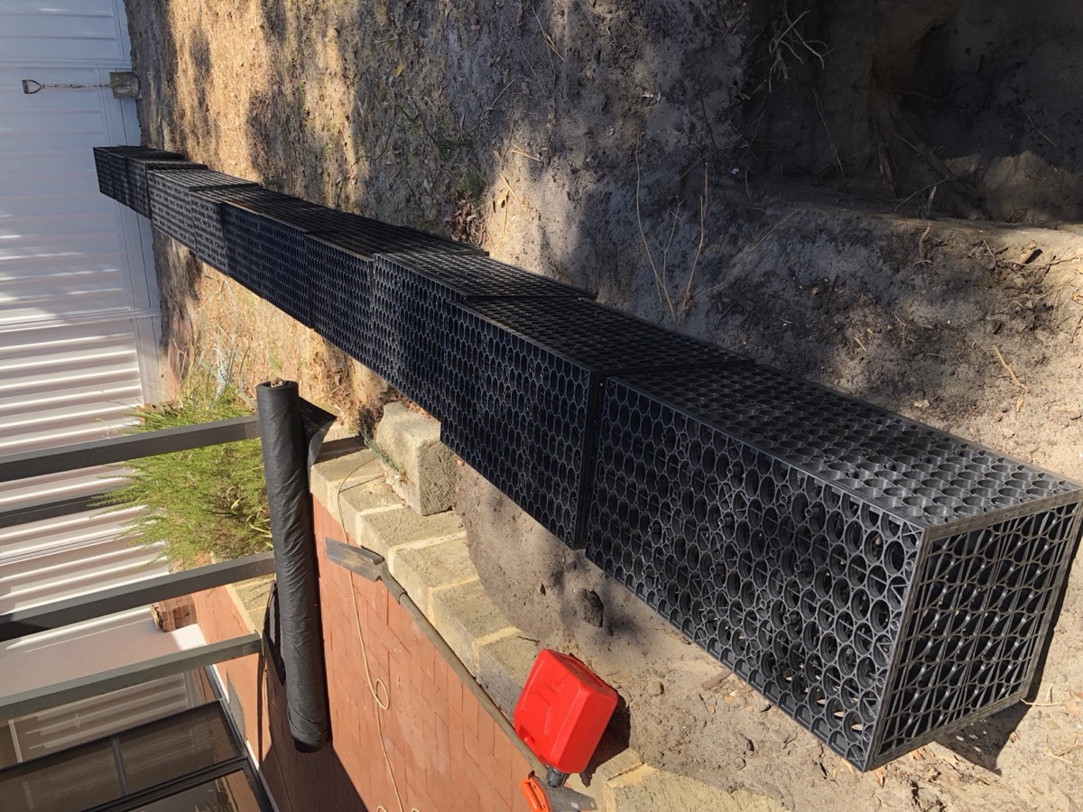 Close view of modular soakwell system in rear-yard trench