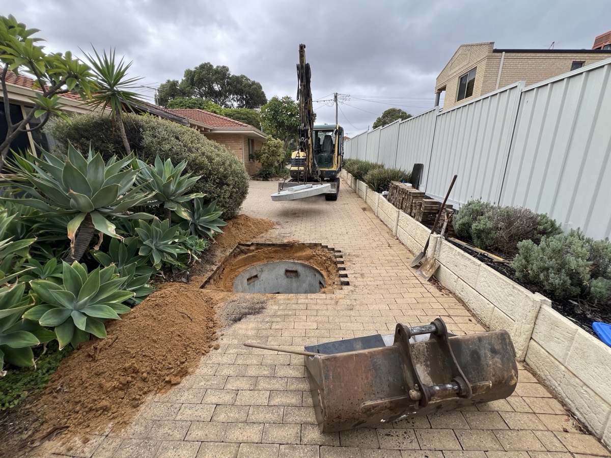 Driveway excavation opened for a stormwater collection pit upgrade